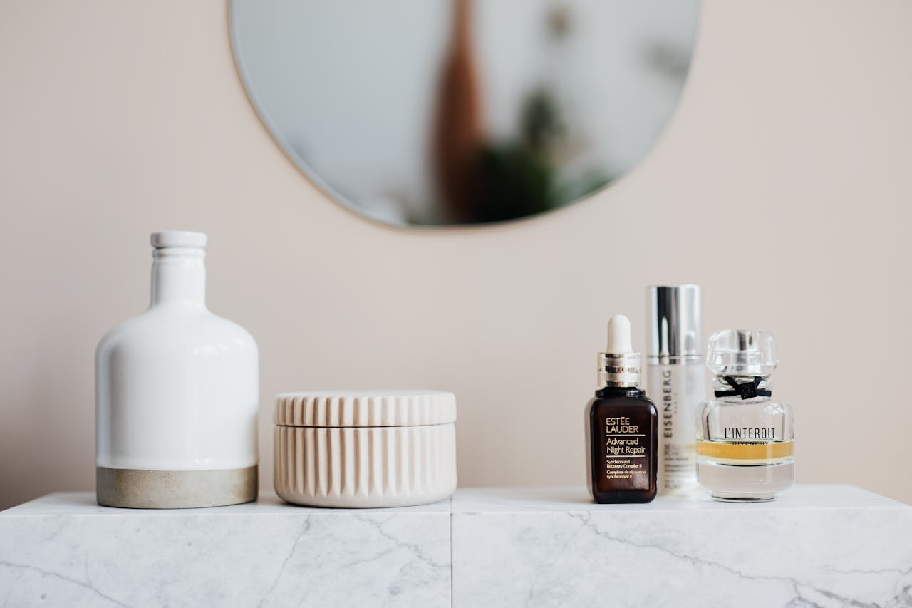 Various beauty products on ceramic shelf in bathroom